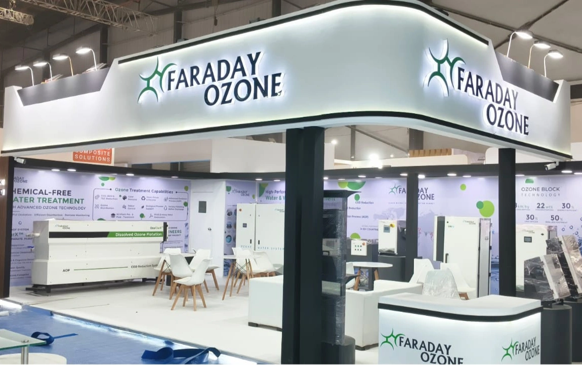 Turnkey Industrial Booth Construction for Faraday Ozone at Exhibition in Mumbai Turnkey industrial exhibition booth designed and constructed by Orange Stall Fabrication for Faraday Ozone in Mumbai with dual-sided curved 3D backlit fascia and equipment demonstration areas