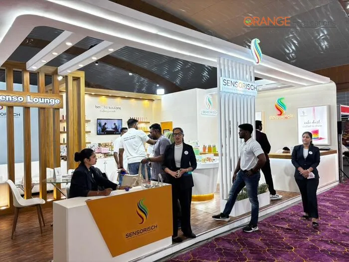 sensorisch custom food ingredients exhibition stall in kochi custom wooden food ingredients exhibition booth with wooden louvers illuminated branding canopy and reception counter in kochi
